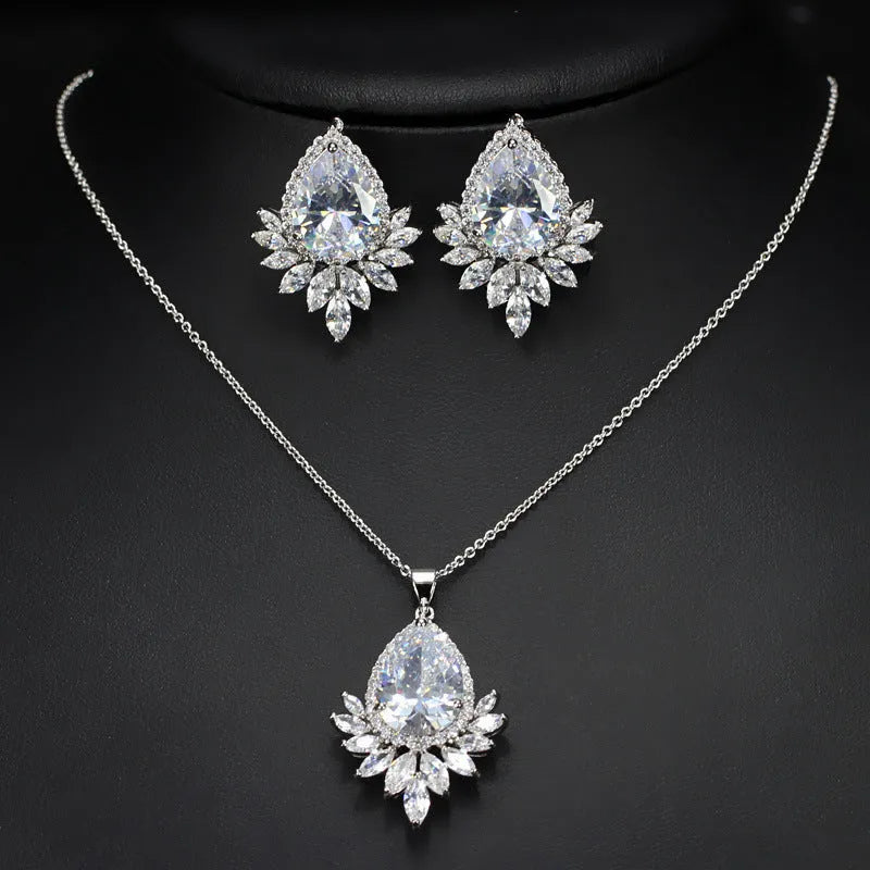 Silver-tone formal jewellery set with simulated diamonds and crystals, includes necklace and bracelet in blue, red, or white.