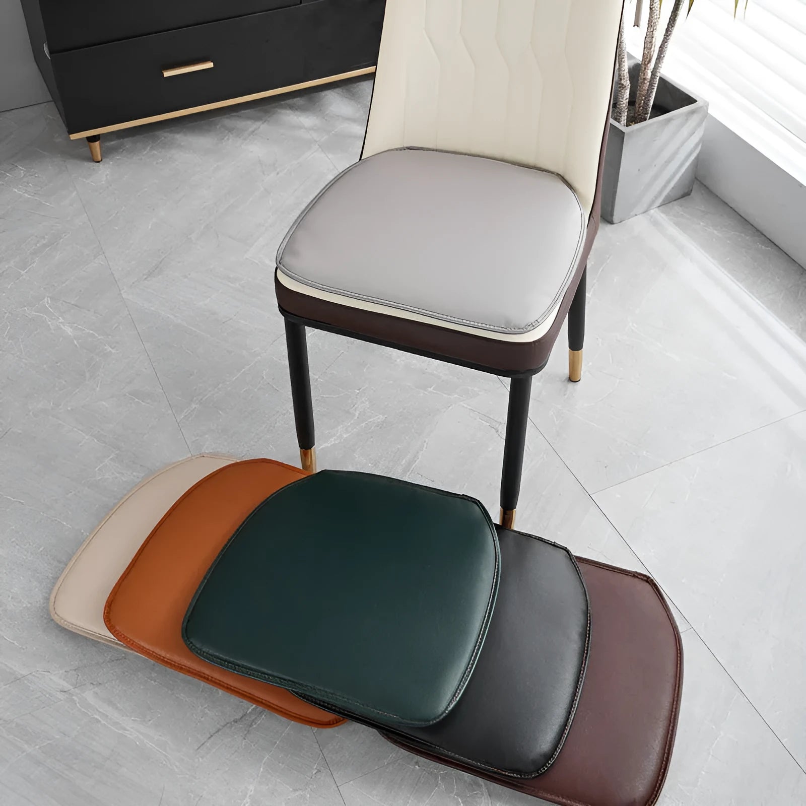 Leather horseshoe-shaped non-slip seat cushion in a solid colour on a chair.