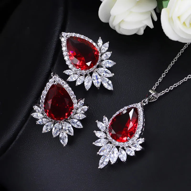 Silver-tone formal jewellery set with simulated diamonds and crystals, includes necklace and bracelet in blue, red, or white.