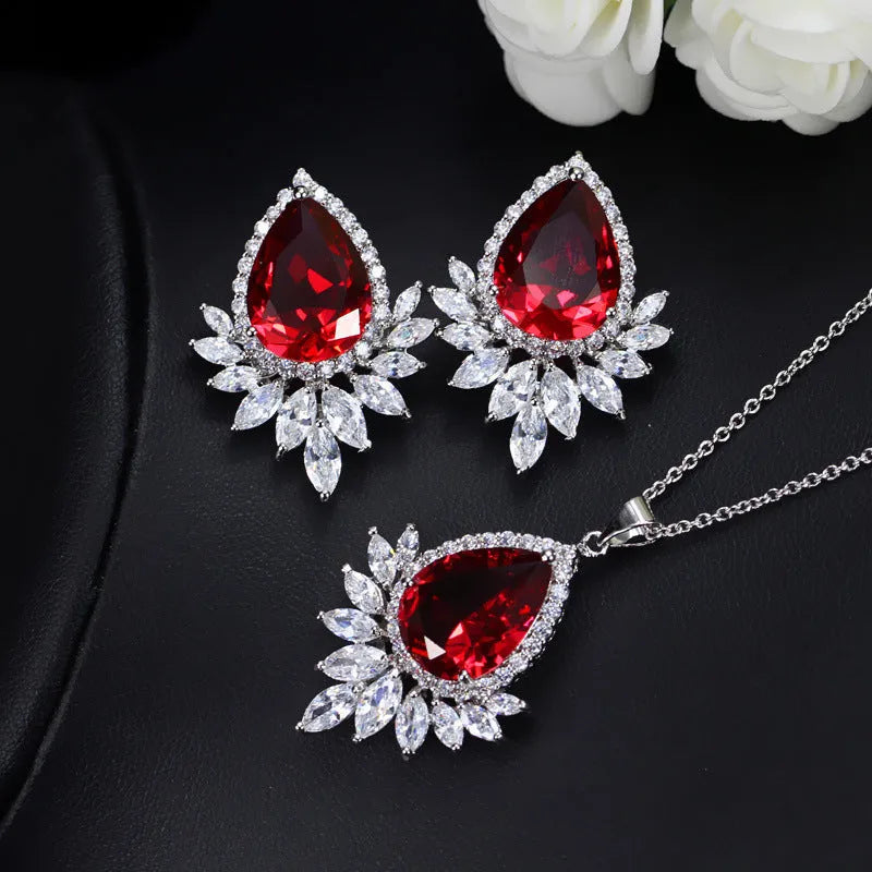 Silver-tone formal jewellery set with simulated diamonds and crystals, includes necklace and bracelet in blue, red, or white.