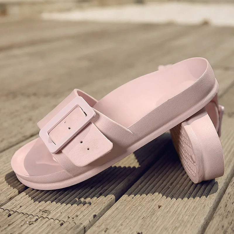 Women's grey blue buckle slippers with a flip-flop design and soft EVA sole on a white background