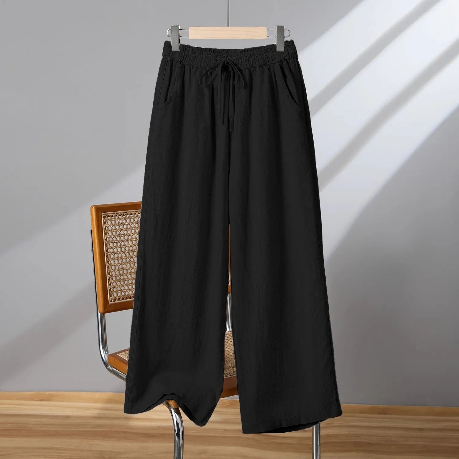 Women's apricot straight-leg casual trousers with elastic drawstring waist laid flat.