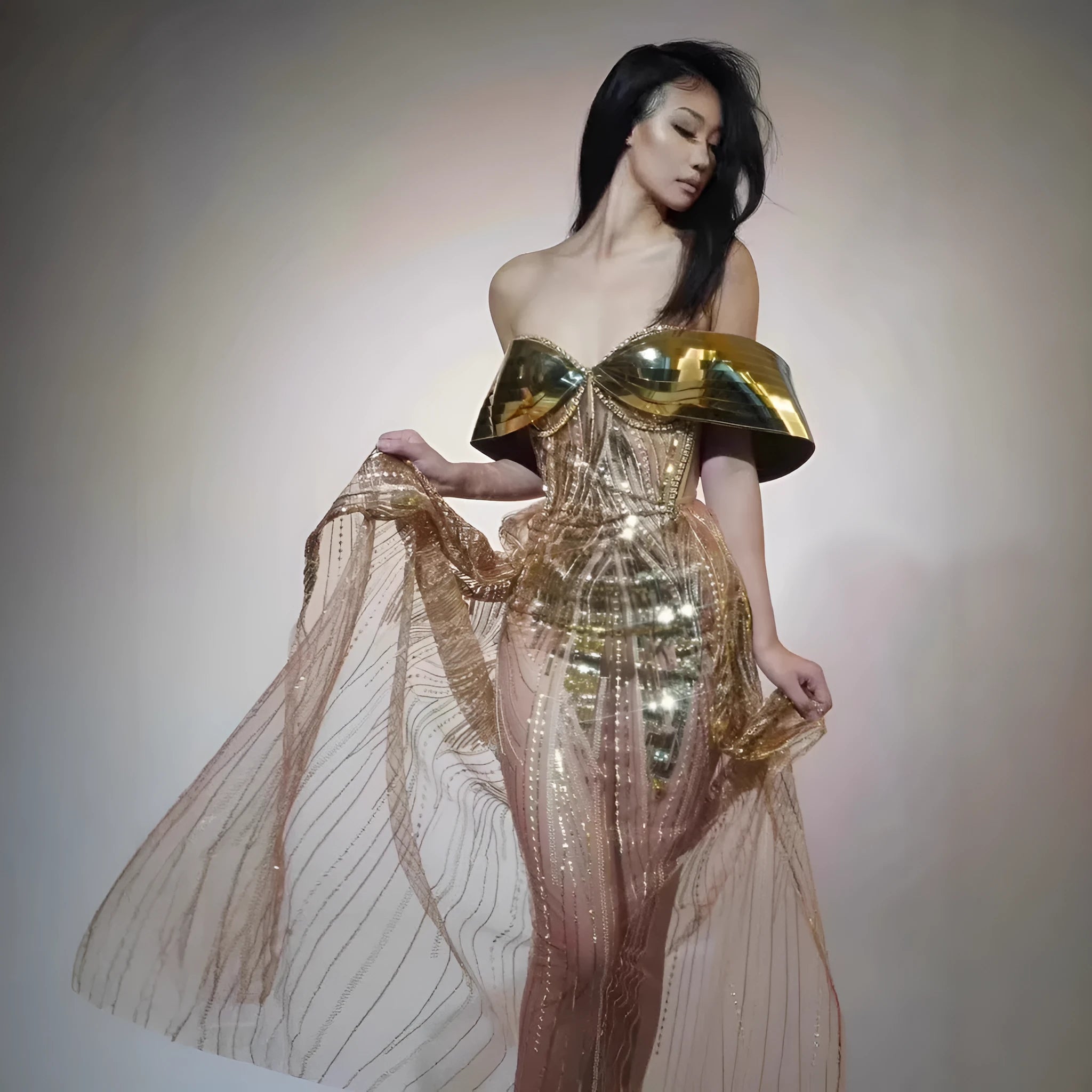 Gold strapless sequined evening dress with a high split tulle skirt.