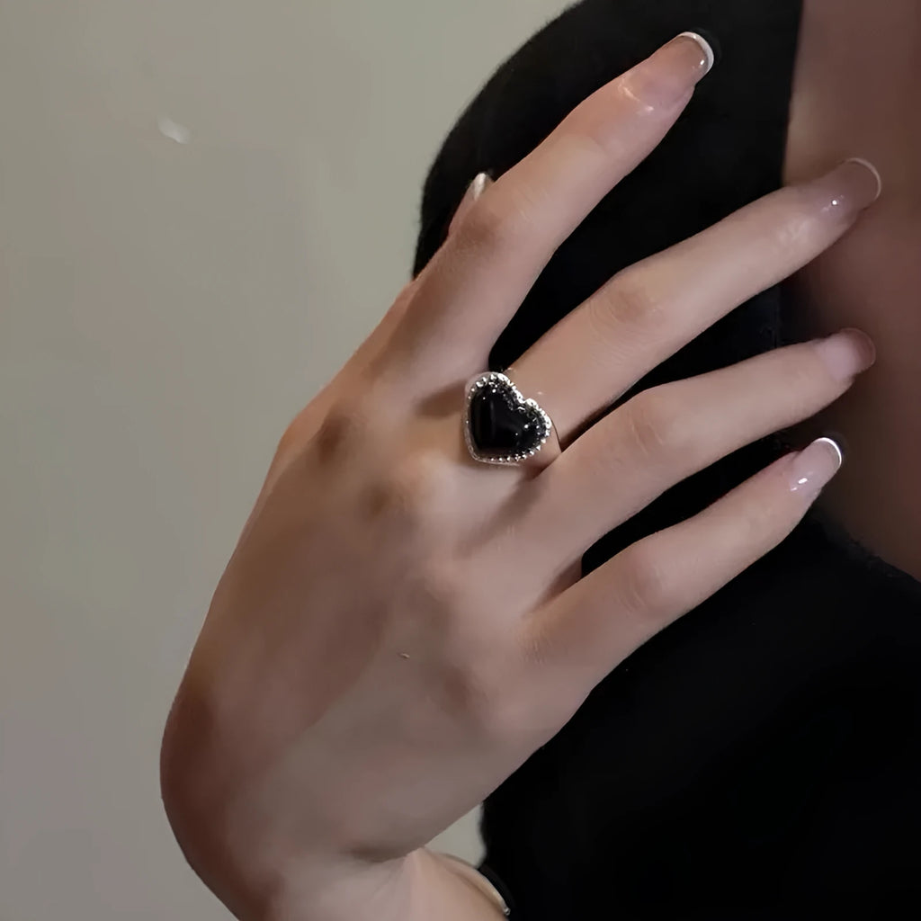 Adjustable open-mouth sterling silver ring with a black heart-shaped agate stone.