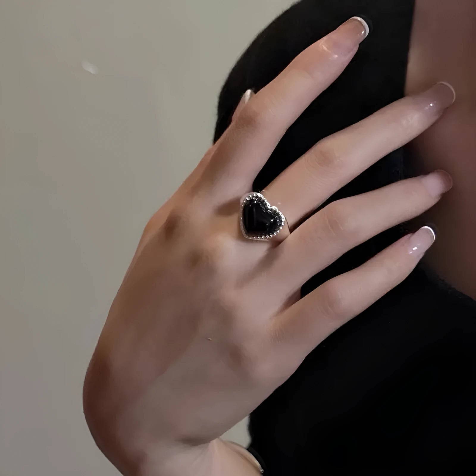 Adjustable open-mouth sterling silver ring with a black heart-shaped agate stone.