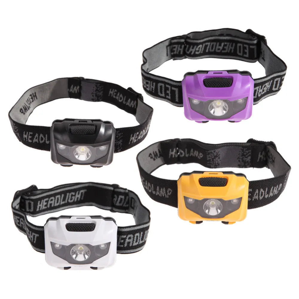 Black head torch with white and red LEDs mounted on adjustable headband for outdoor use
