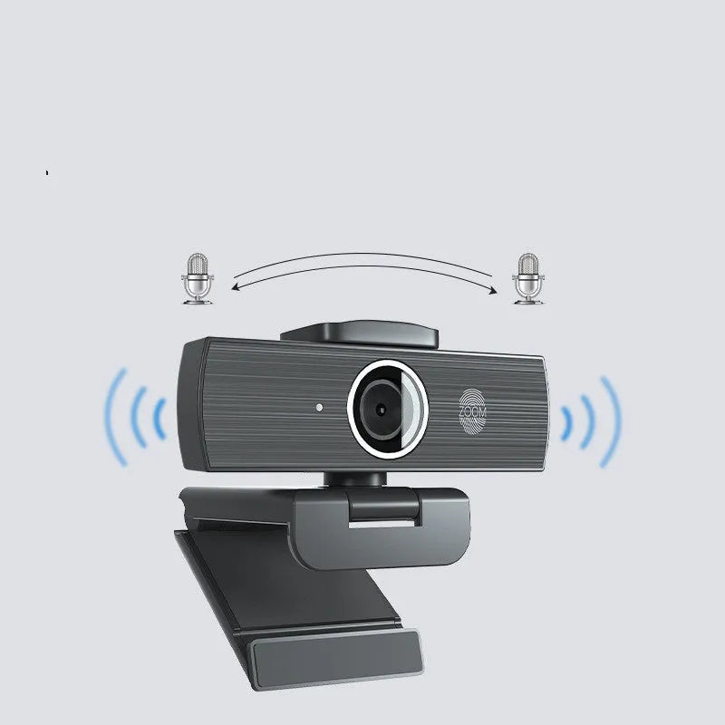 Black USB webcam with attached cable and a magnetic privacy cover on a desk.