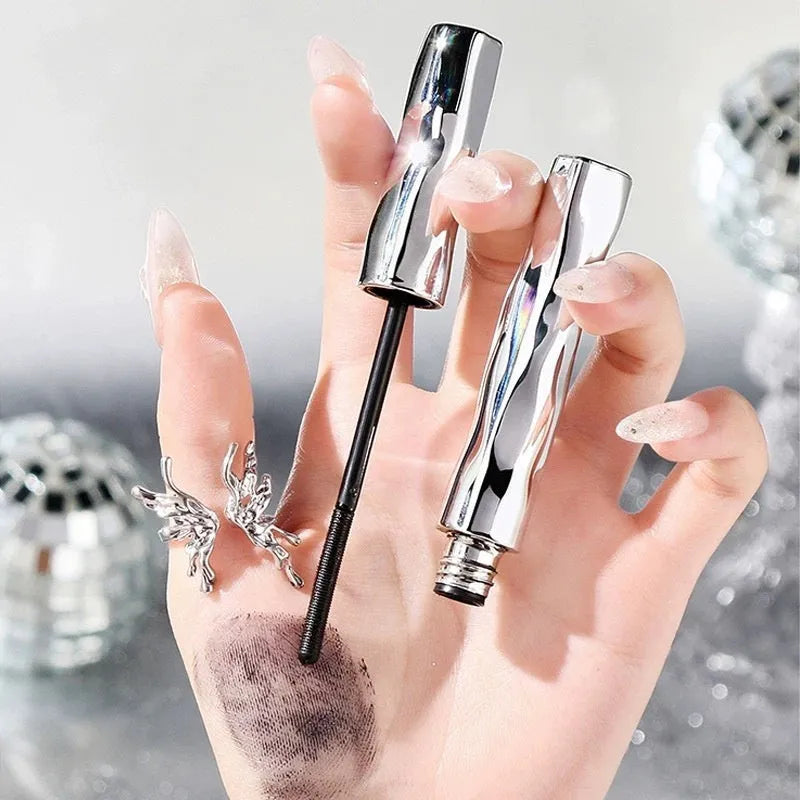 Waterproof steel tube mascara in black and brown shades shown with an eyelash curler.