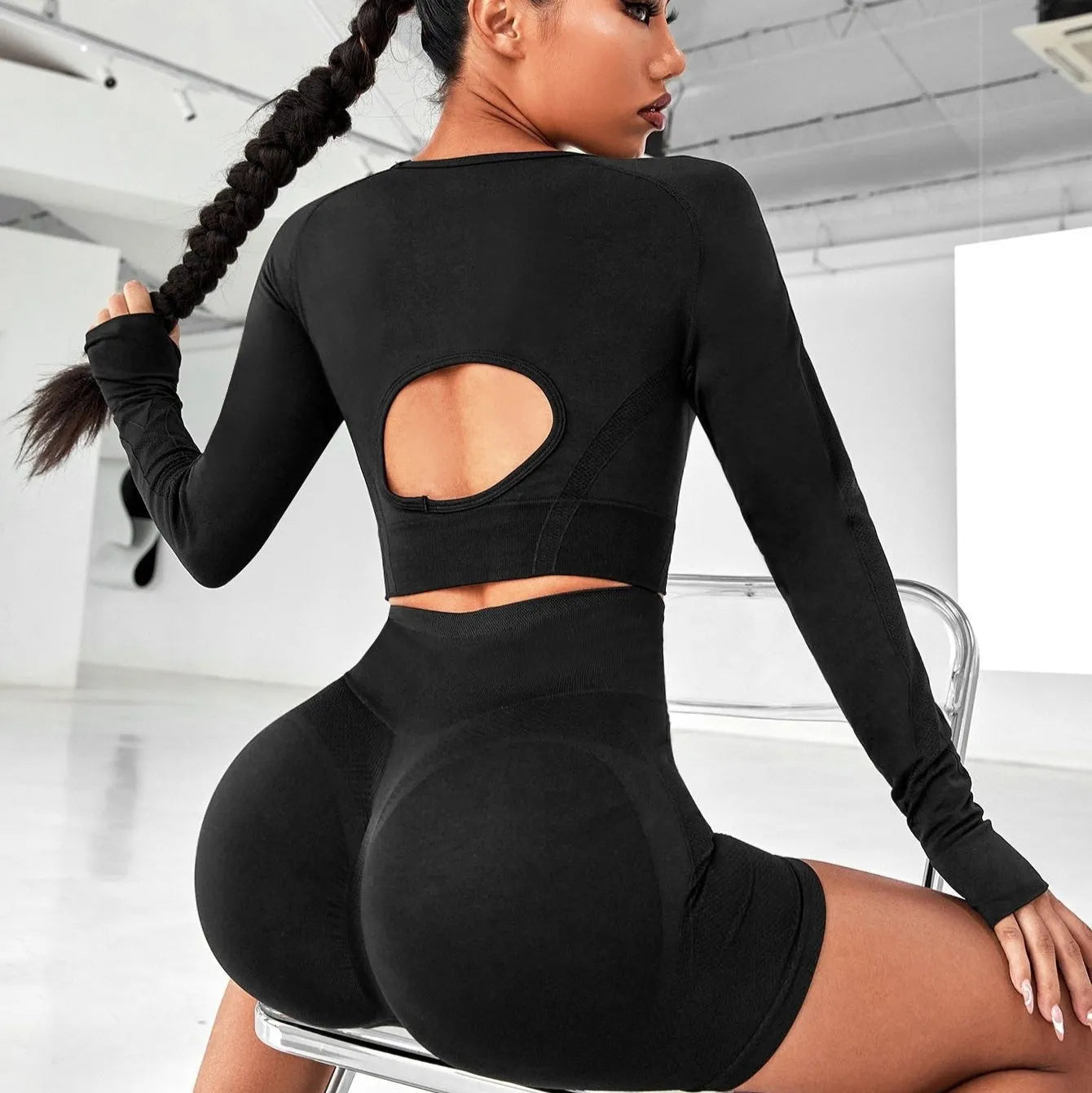 Women's black high-waisted yoga suit set with long sleeves and tight fit
