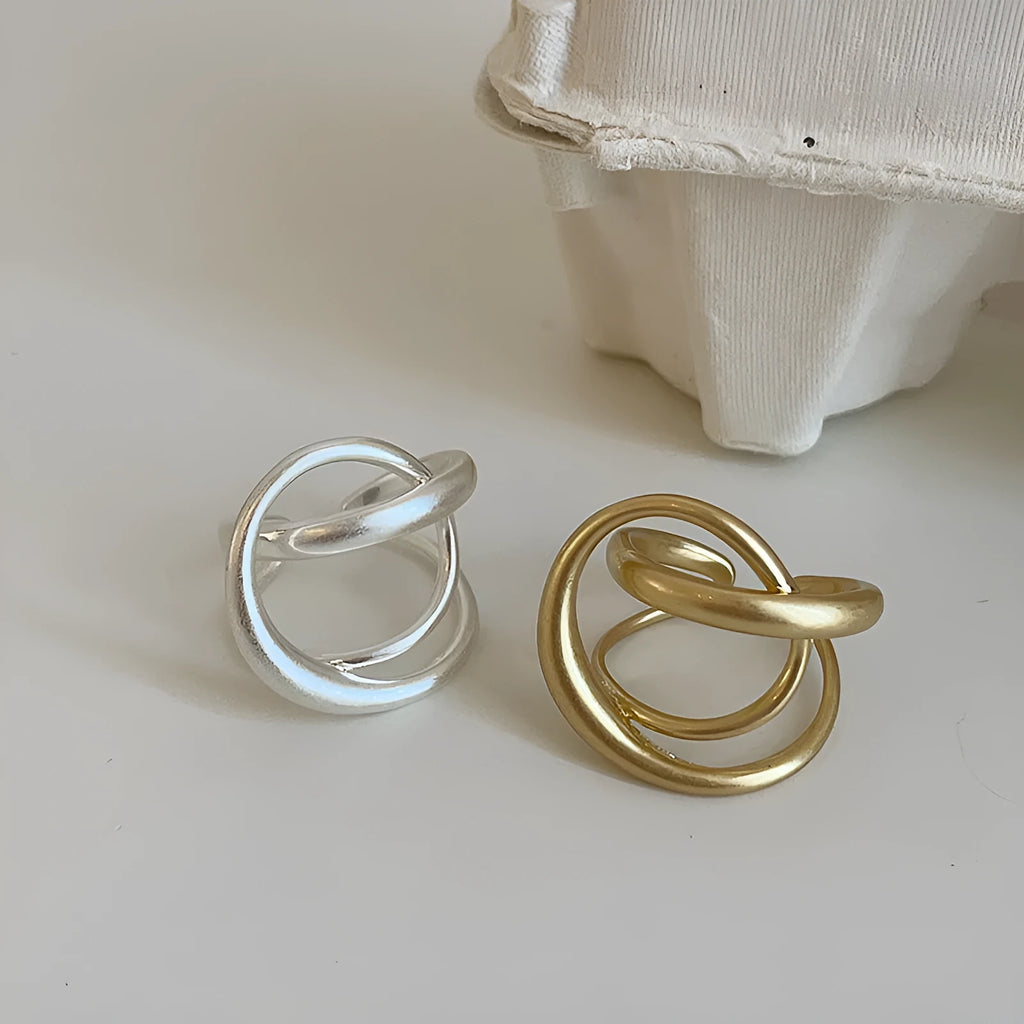 Geometric open ring with three-dimensional interlaced matte metal design in gold or silver electroplated finish