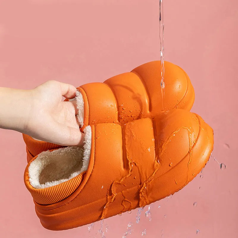 Women's green waterproof EVA winter slippers with plush lining and a non-slip sole.