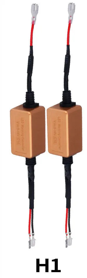 Black alloy LED Canbus decoder for H4 H7 H11 car headlight bulbs on a white background.