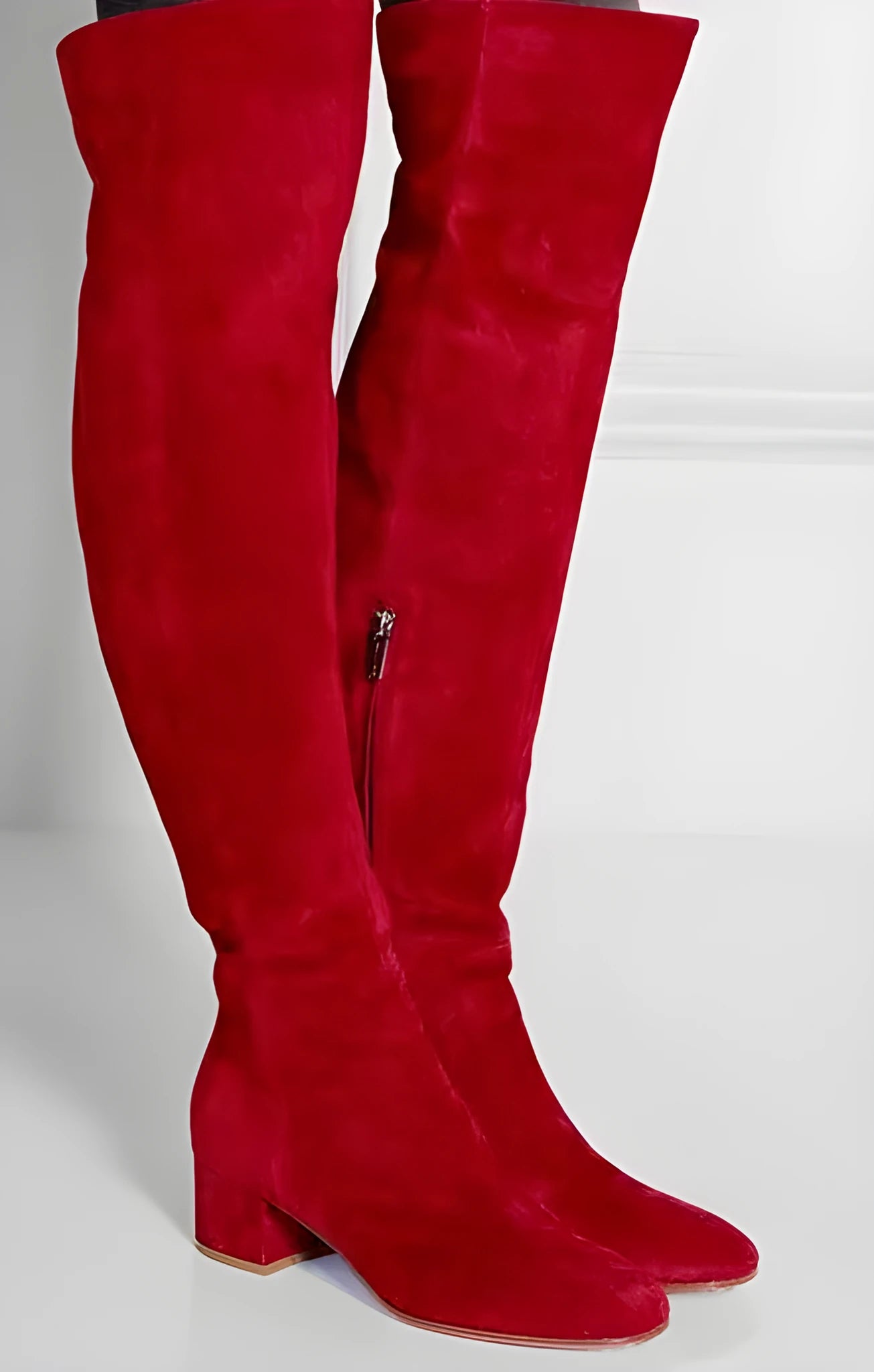 Grey suede women's over the knee flat boots with a pointed toe and low block heel on a neutral background.