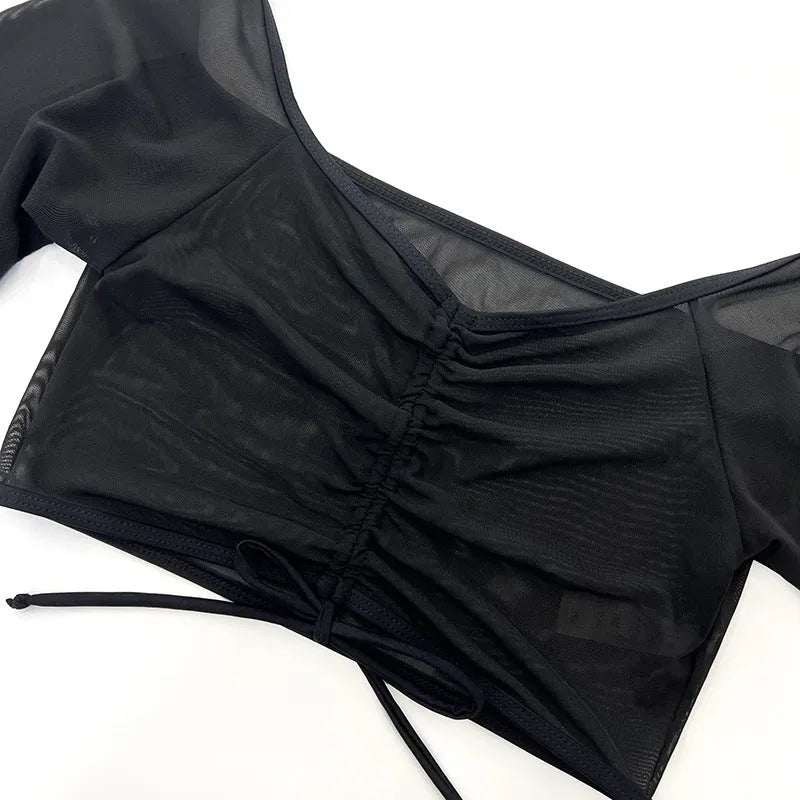 Black women's four-piece bikini swim set with long sleeves and mesh construction for swimming sports