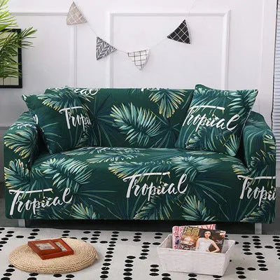 Geometric abstract printed stretch sofa slipcover covering a three-seater sofa with matching cushion covers.