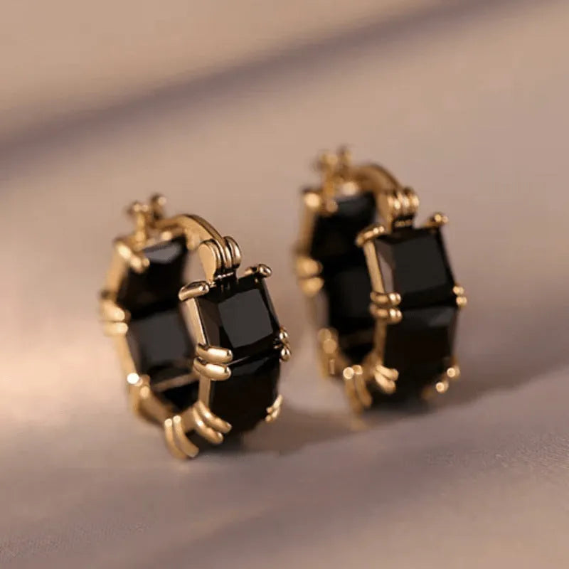 Gold geometric U-shaped women's earrings with a round black zircon stone.