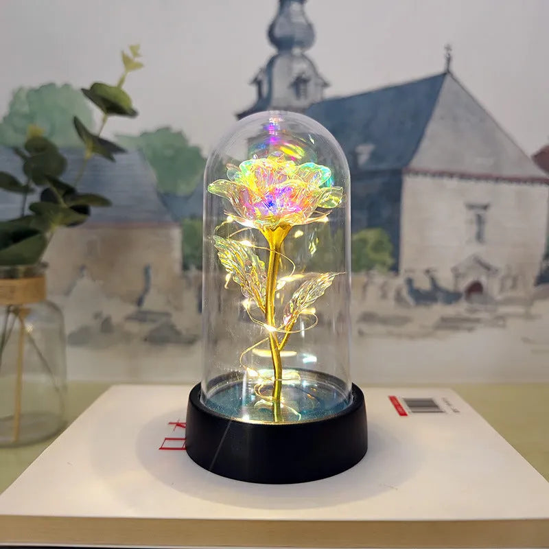Small plastic night lamp with glass cover and flower decoration on black base