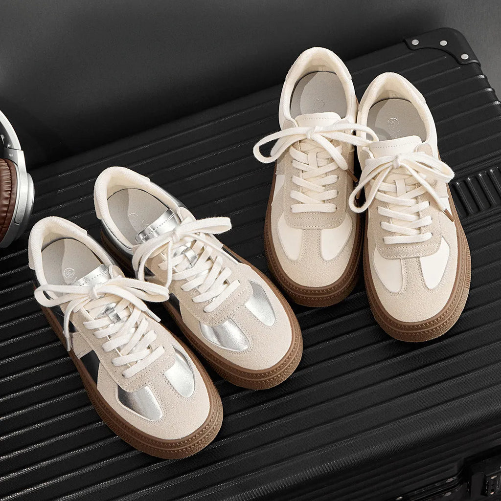 Retro sports shoes with round toe, cross straps, and lace-up front in milky white colour