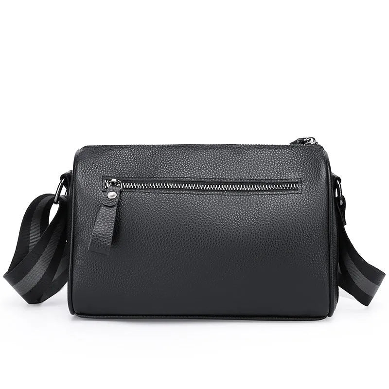 Black genuine leather crossbody bag with adjustable strap and large 24x16x13cm capacity.