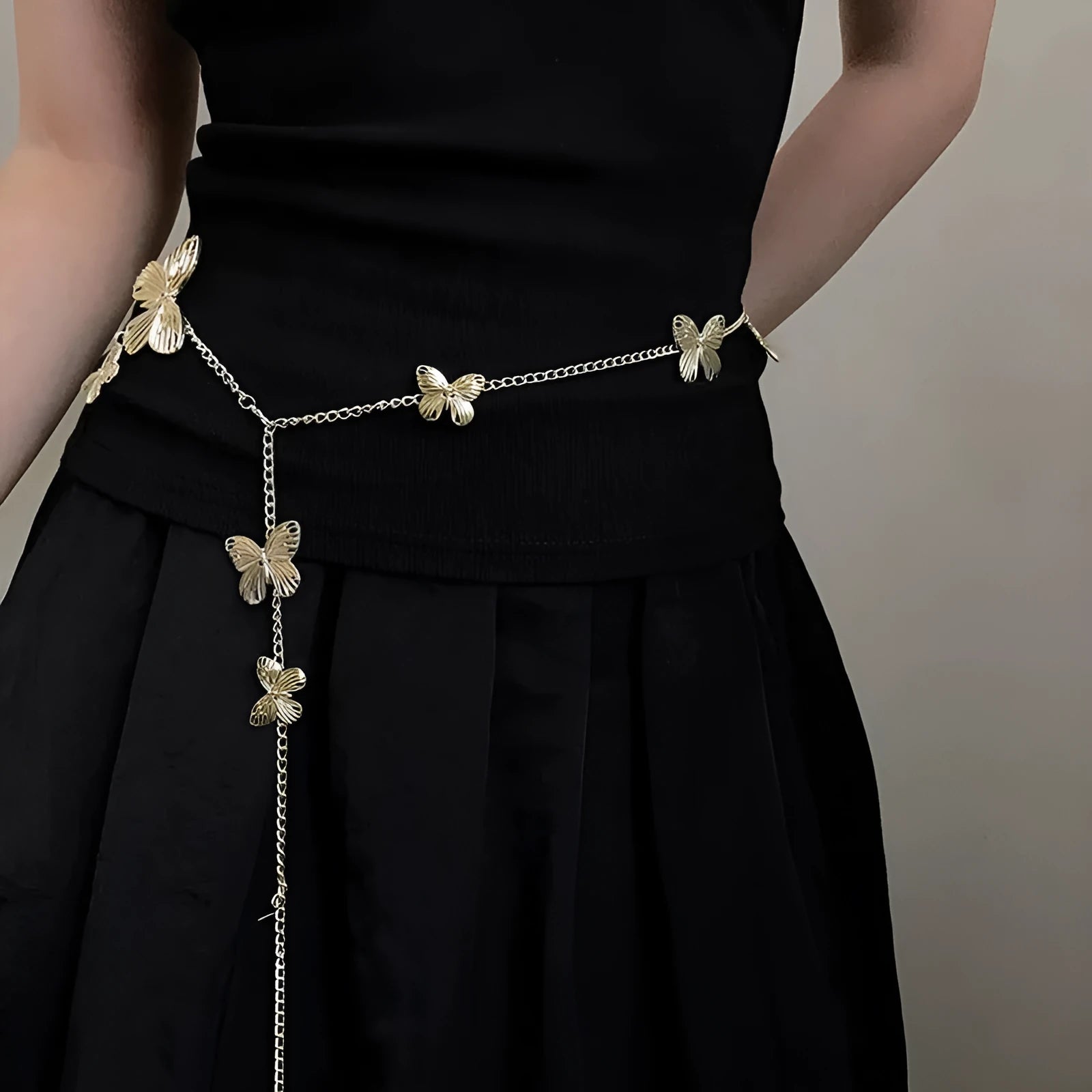 Women's gold butterfly waist chain alloy accessory with 104cm length on model