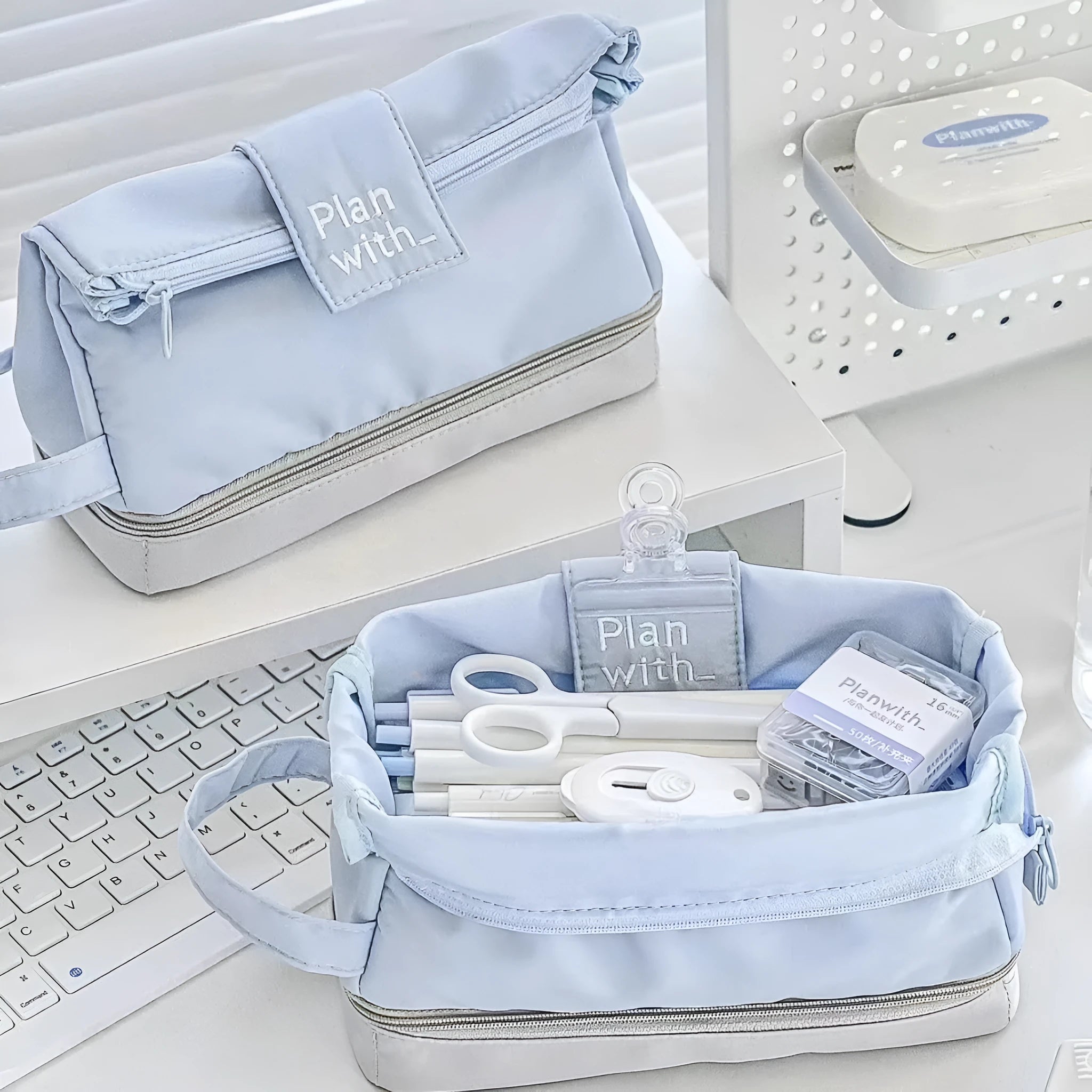 Dark blue folding double-layer polyester pencil case for pens and stationery, shown open to reveal two compartments.