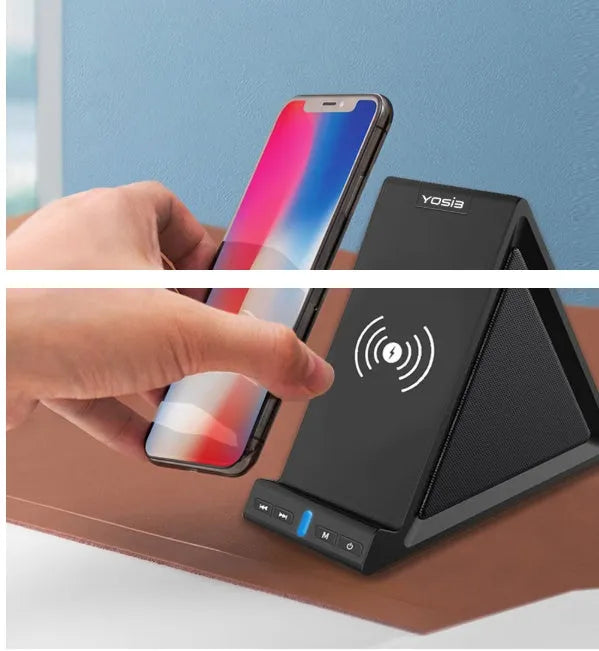 Black ABS Bluetooth speaker with integrated wireless charging pad and phone stand, shown on a desk.