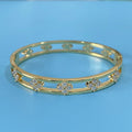 Women's hollow bracelet with four-leaf clover charm and zircon stones in gold or silver tone
