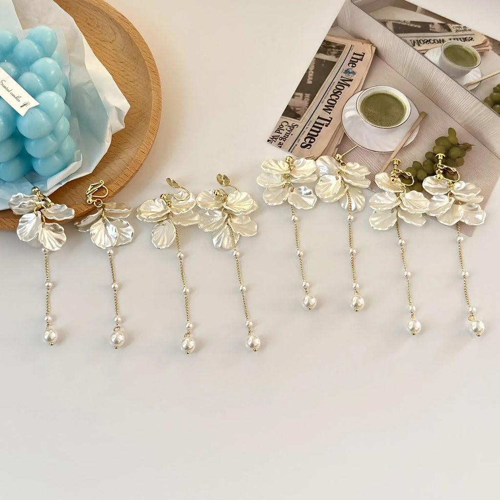Long shell pearl tassel earrings with acrylic construction and multiple ear clip options