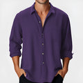 Man wearing a loose-fit long sleeve casual shirt with a stand collar, suitable for beach holidays.
