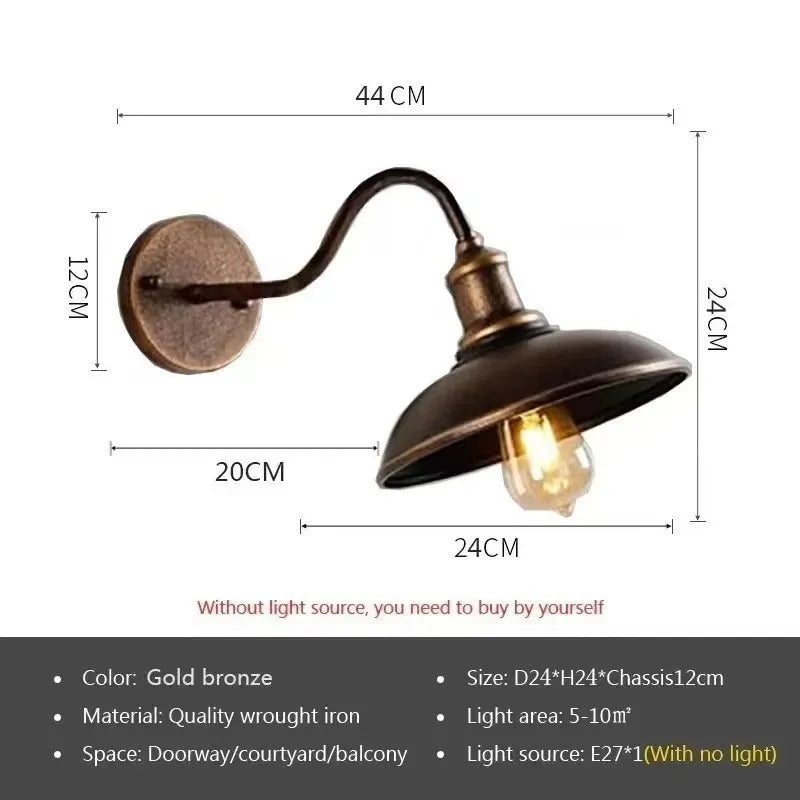 Retro style metal wall lamp in copper finish mounted on a stone wall.