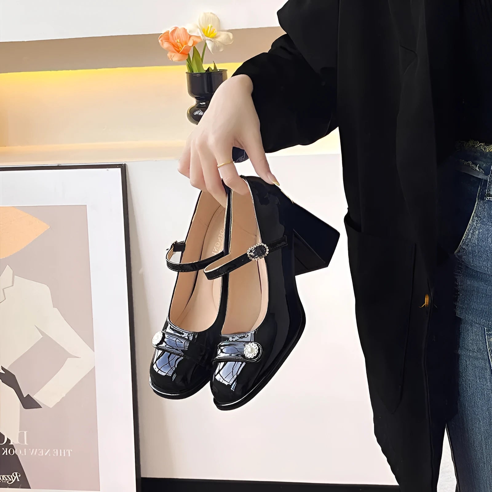 Women's black patent leather wide-fit chunky heel shoes with round toe and buckle fastening.
