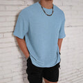 Men's loose fit light blue short sleeve round neck t-shirt on a hanger.