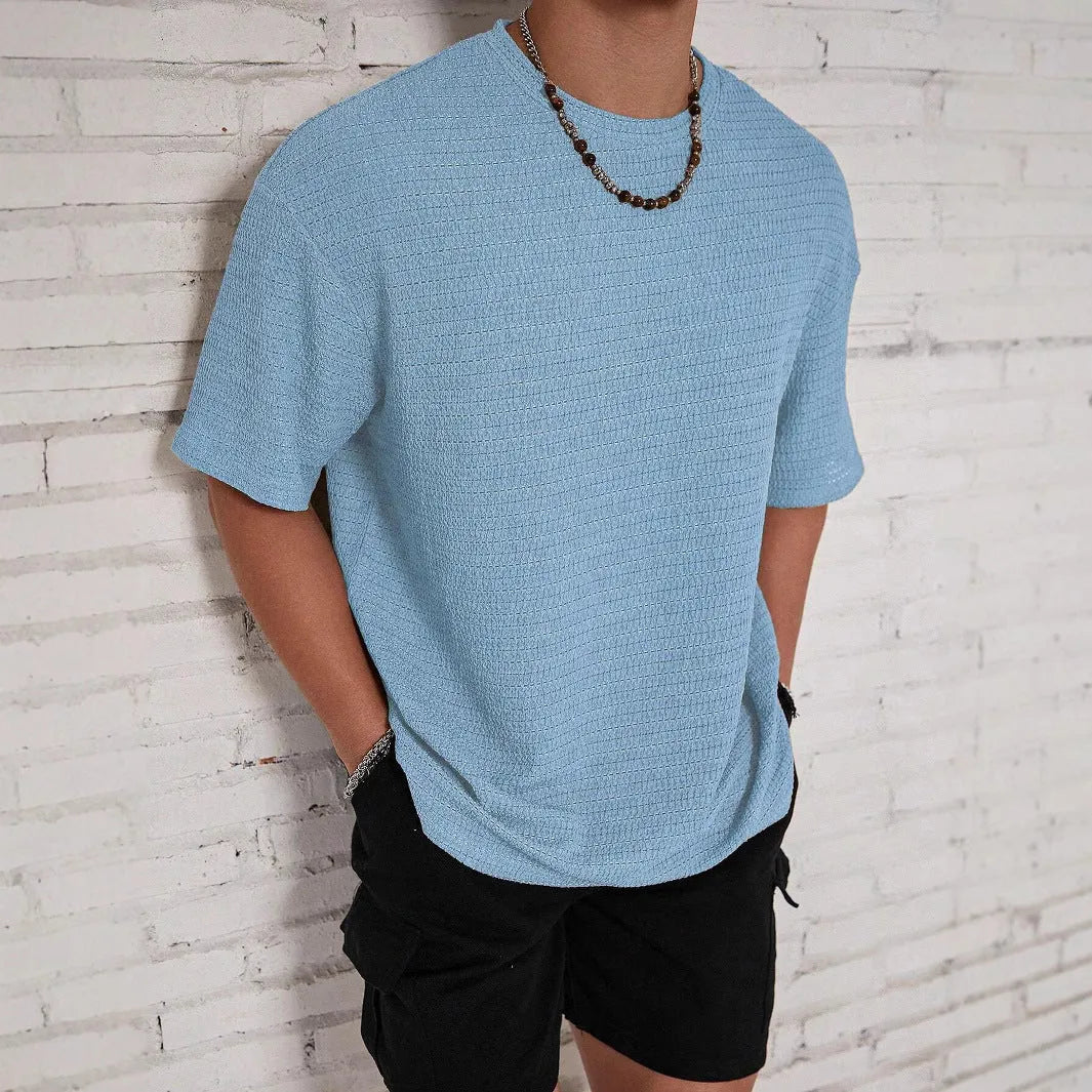 Men's loose fit light blue short sleeve round neck t-shirt on a hanger.