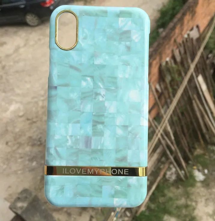 Marble pattern plastic case for iPhone on a table, shown in multiple colour options.