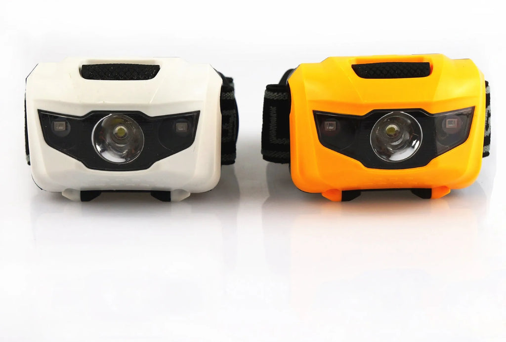 Black head torch with white and red LEDs mounted on adjustable headband for outdoor use