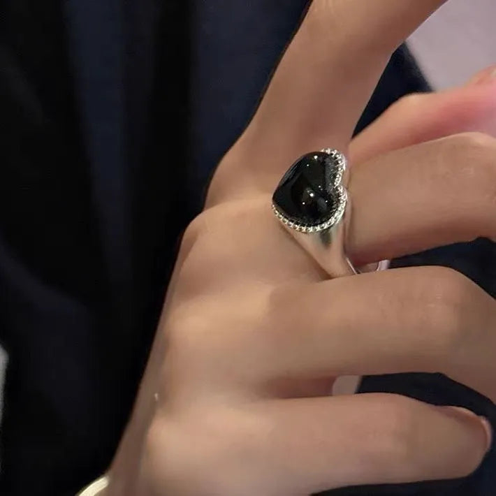 Adjustable open-mouth sterling silver ring with a black heart-shaped agate stone.