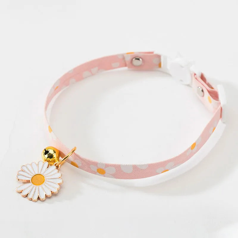Green adjustable cat collar with a metal bell pendant and a matching bow tie on a white background.
