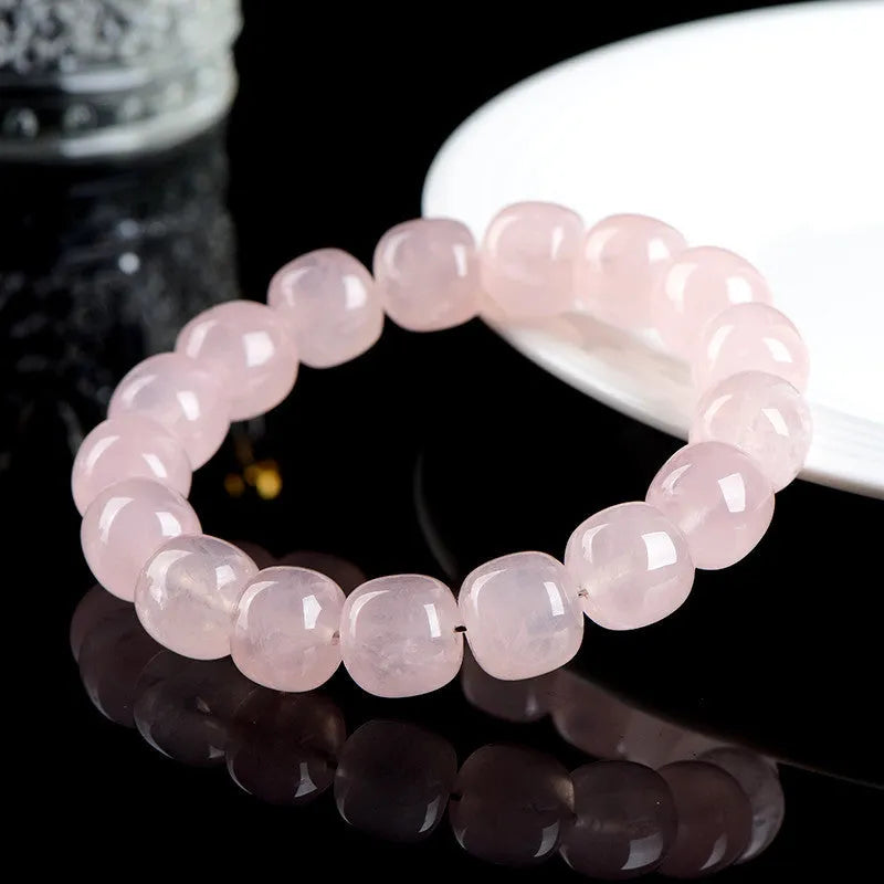 Pink crystal barrel bead bracelet with geometric design for men and women.