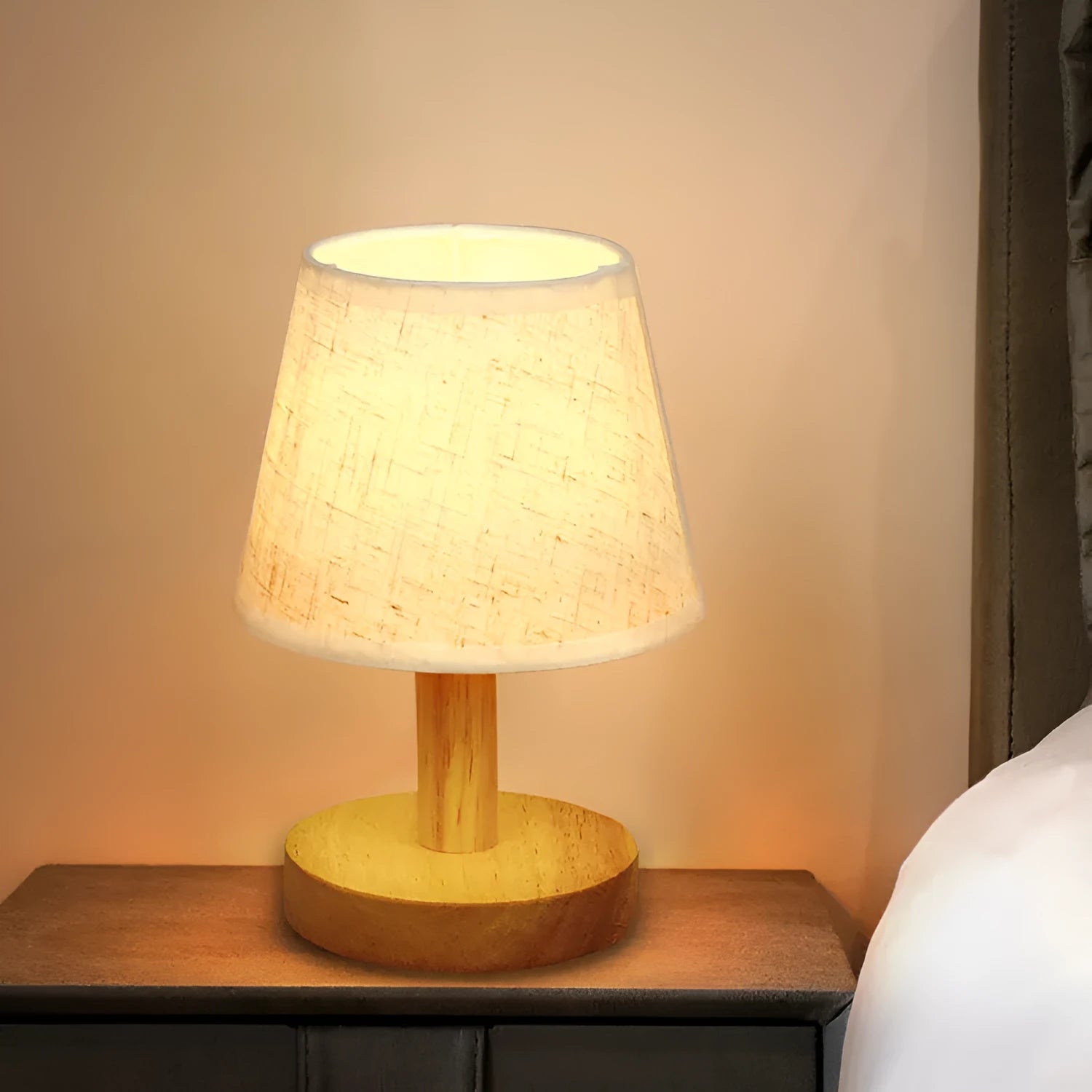 Vintage pleated table lamp with jute shade and bamboo base on a wooden table.