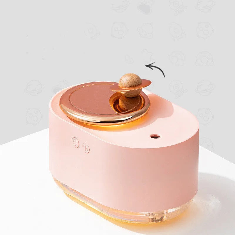 Rotating planet desktop humidifier with night light in green colour showing USB charging port and water tank