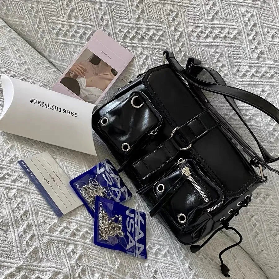 Black structured PU leather women's baguette messenger bag with adjustable long shoulder strap.