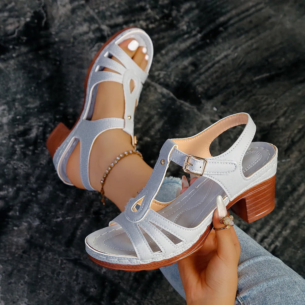Women's black peep toe wedge sandals with a buckle fastening on a white background.