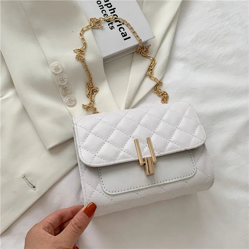Women's crossbody bag with diamond lattice chain detailing and adjustable shoulder strap