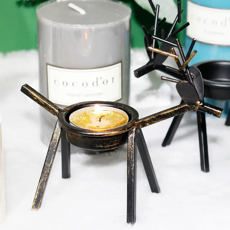 Black iron Christmas candlestick holder with decorative elk antler design.