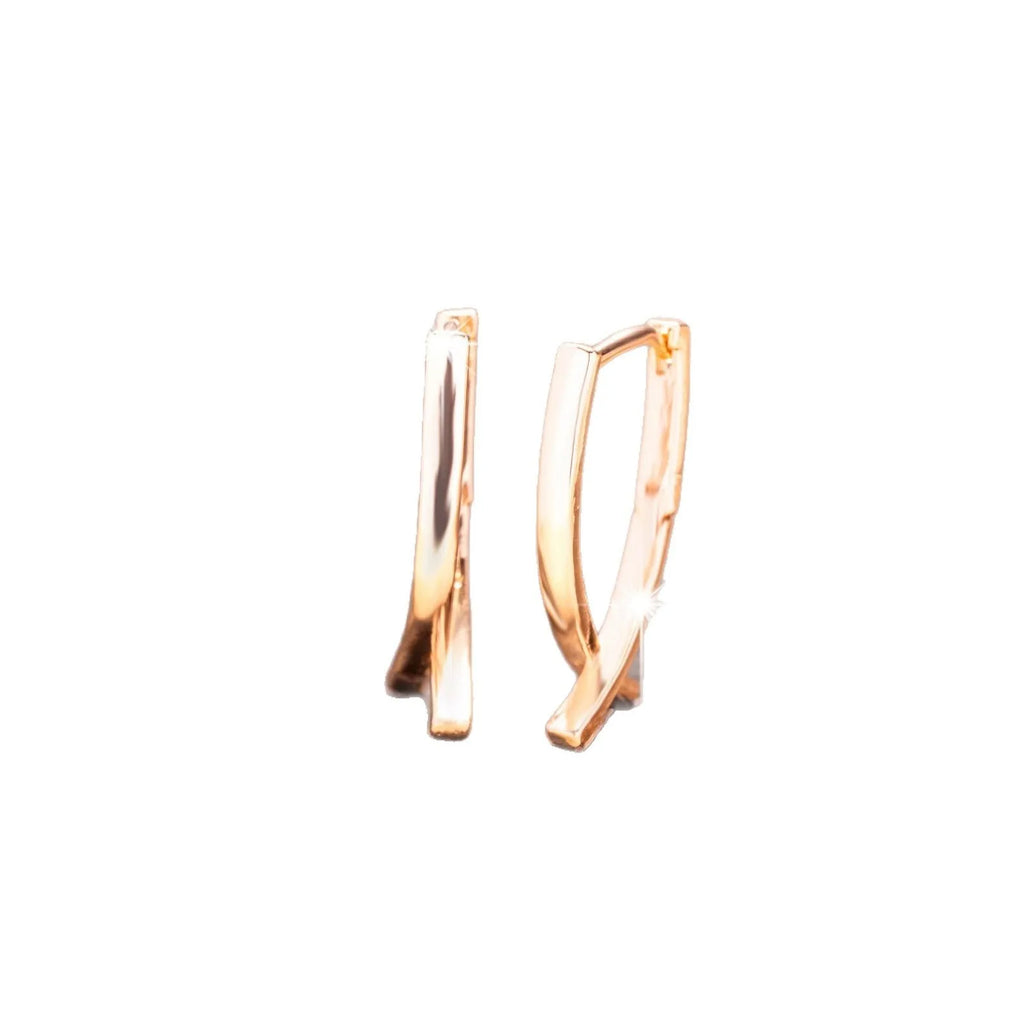 Rose gold cross shaped earrings with polished finish on copper construction