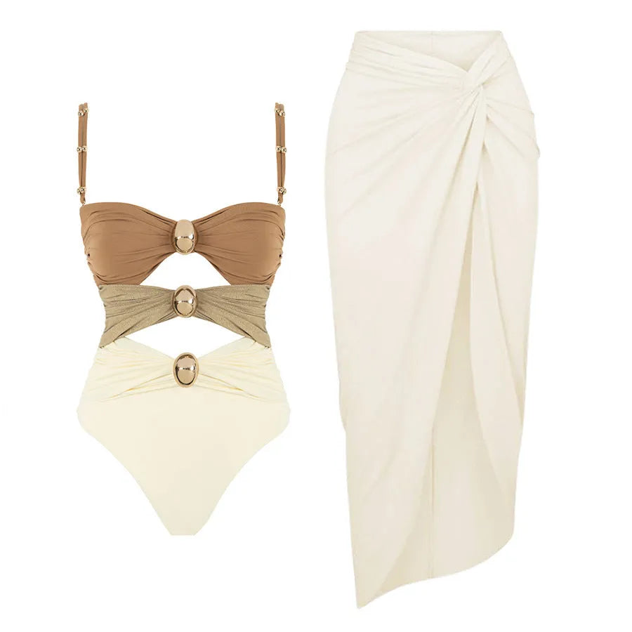 Women's one-piece swimsuit with matching skirt in assorted colours showing gold button detail