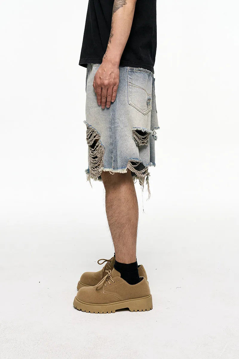 Light blue men's baggy denim shorts with wide leg and mid waist on a plain background