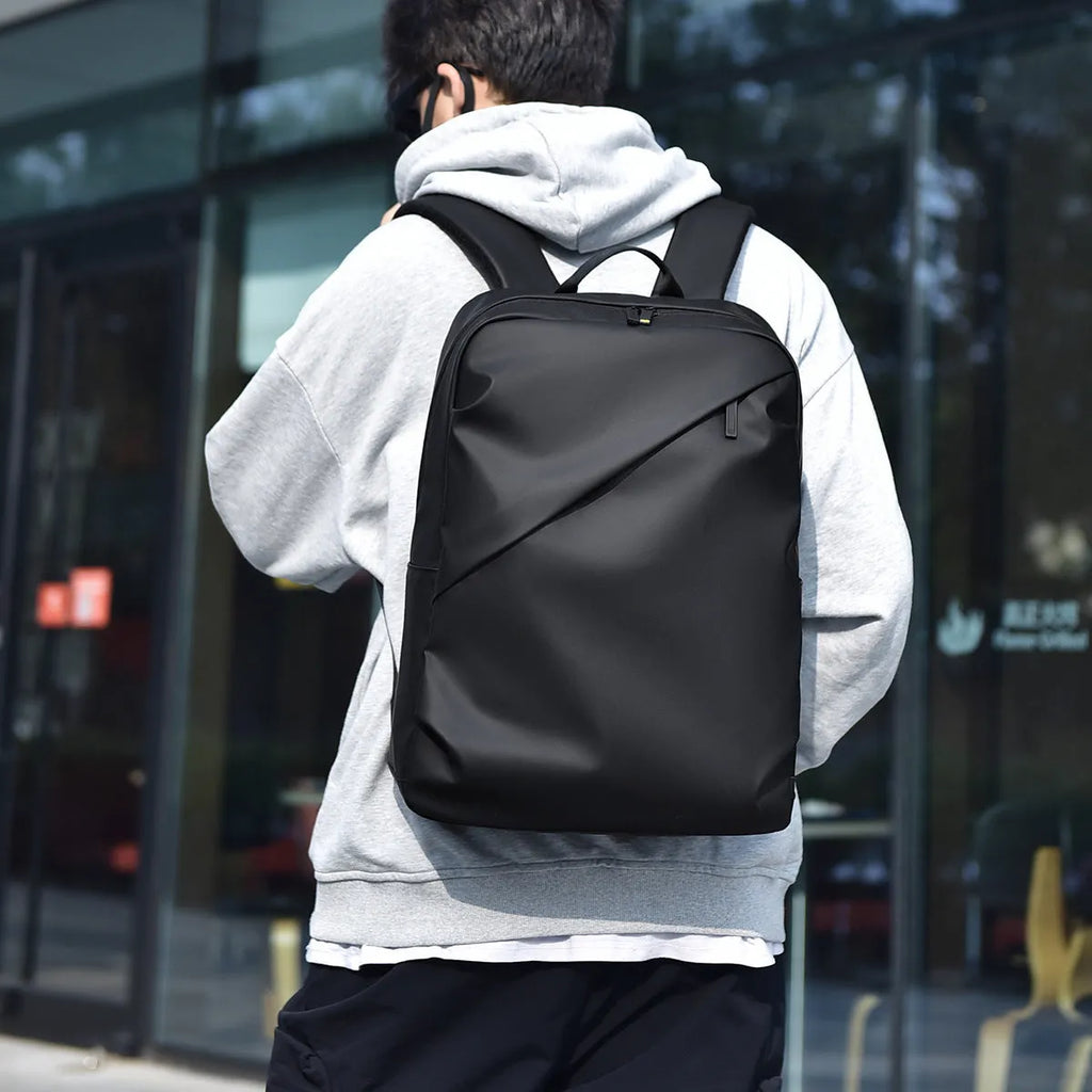Men's large waterproof PU backpack in black, blue, or grey showing sewing thread details