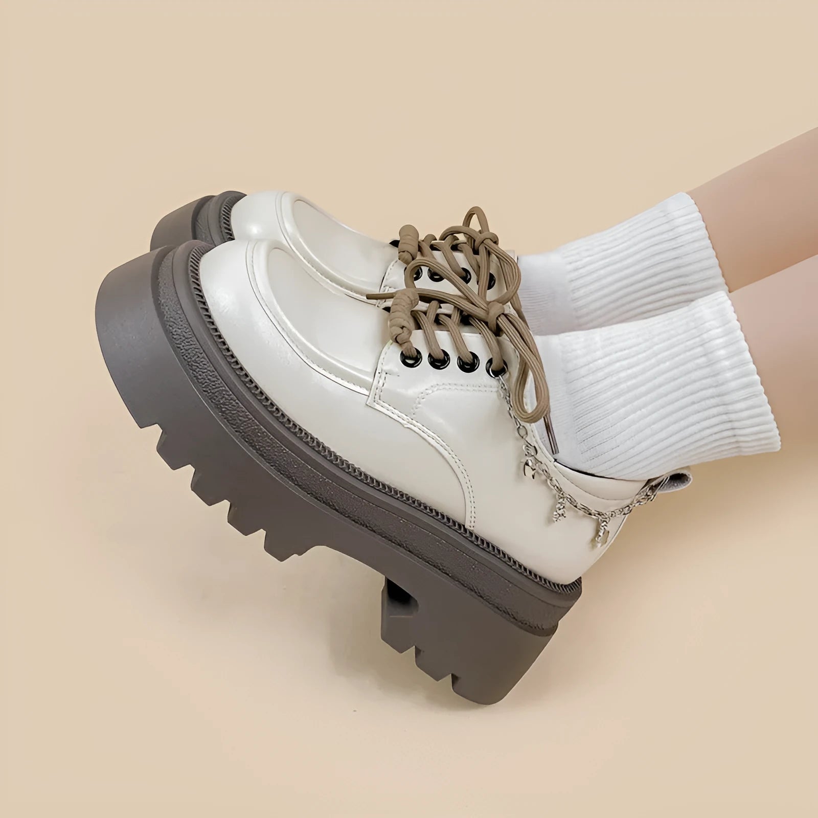 White platform Mary Jane shoes with chunky heel and round toe, front lace-up design