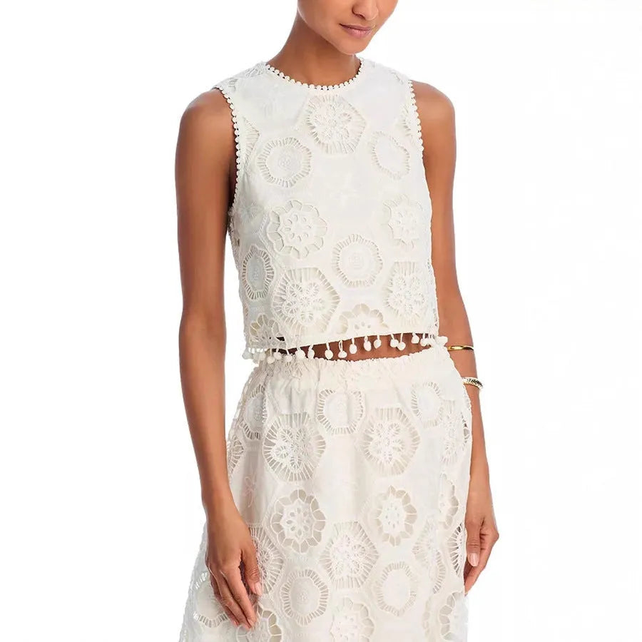 White women's two-piece suit with sleeveless top, long skirt, and embroidery detail.